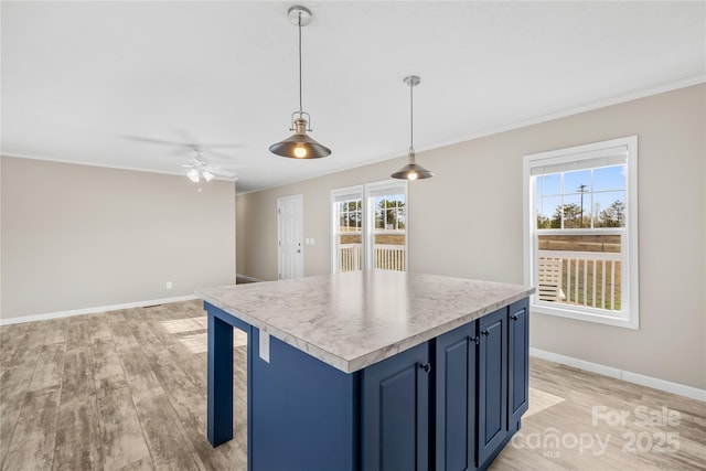 kitchen with blue cabinetry, baseboards, light wood-style floors, and light countertops