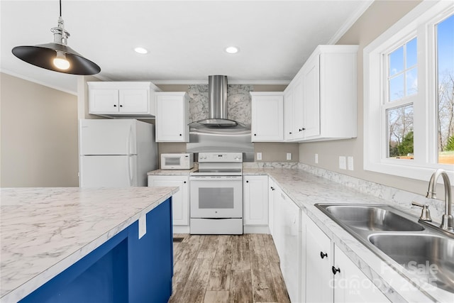 kitchen featuring crown molding, white appliances, wall chimney exhaust hood, and a sink