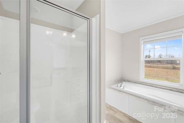 full bath with crown molding, a bath, wood finished floors, and a stall shower