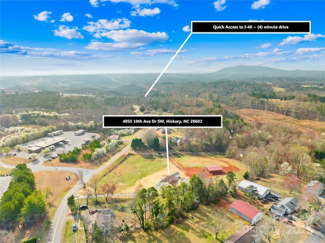 aerial view with a mountain view and a view of trees