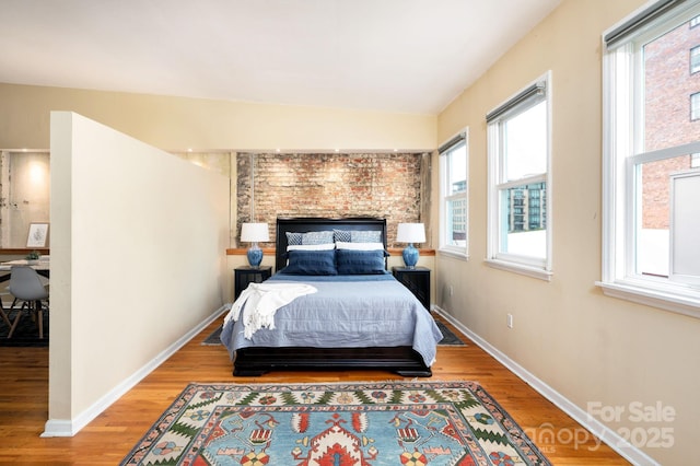32 Broadway St Unit 330, Asheville, NC 28801 - bedroom featuring multiple windows, wood finished floors, and baseboards