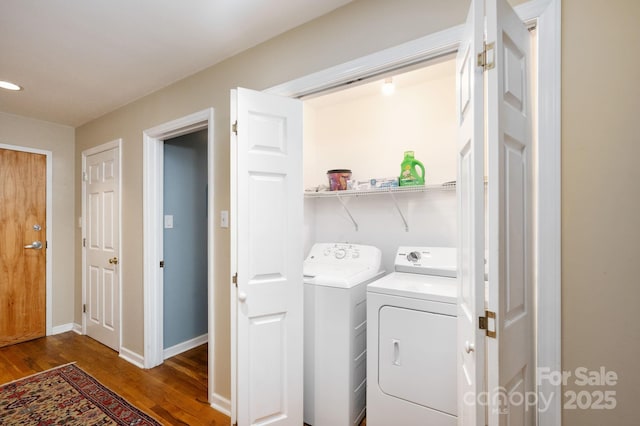 32 Broadway St Unit 330, Asheville, NC 28801 - laundry area featuring wood finished floors, washer and dryer, and baseboards