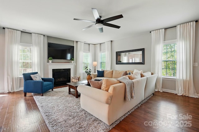 5140 Oak Grove Pl, Waxhaw, NC 28173 - living room featuring ceiling fan, wood-type flooring, a glass covered fireplace, and a wealth of natural light