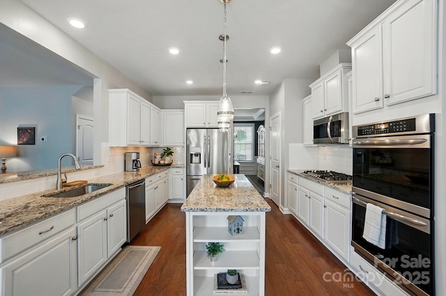 5140 Oak Grove Pl, Waxhaw, NC 28173 - kitchen with dark wood-style floors, white cabinetry, backsplash, appliances with stainless steel finishes, and a sink