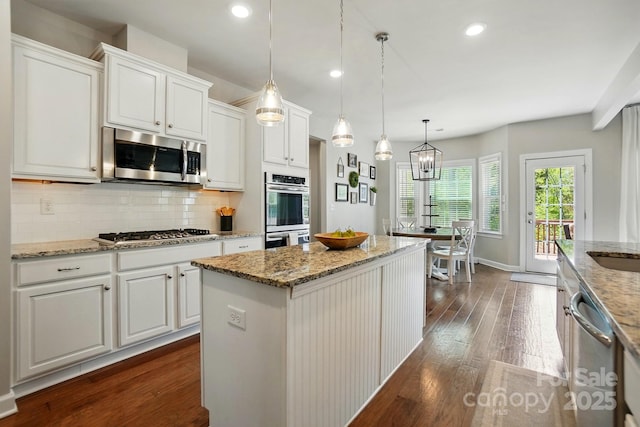 5140 Oak Grove Pl, Waxhaw, NC 28173 - kitchen featuring light stone counters, white cabinetry, dark wood-type flooring, decorative backsplash, and stainless steel appliances