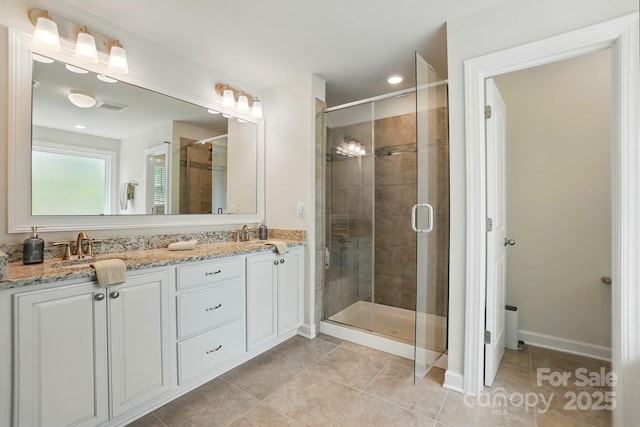5140 Oak Grove Pl, Waxhaw, NC 28173 - full bathroom with visible vents, a sink, a stall shower, double vanity, and tile patterned floors