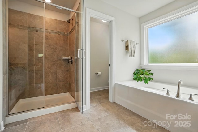 5140 Oak Grove Pl, Waxhaw, NC 28173 - full bathroom featuring a shower stall, tile patterned flooring, baseboards, and a garden tub