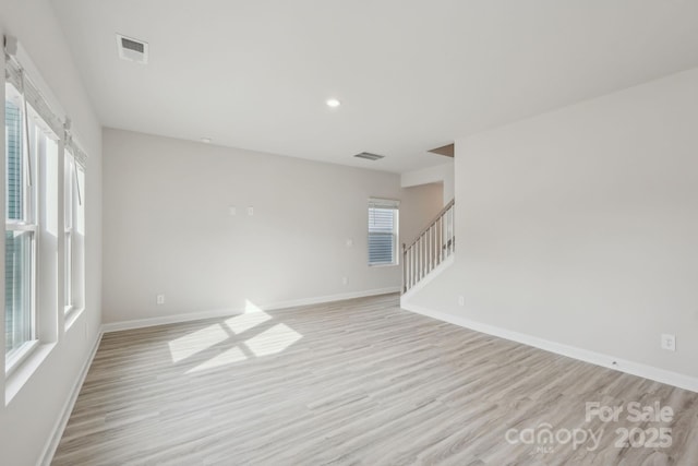 1305 31st St NE, Conover, NC 28613 - unfurnished room featuring light wood-style floors, baseboards, and a healthy amount of sunlight