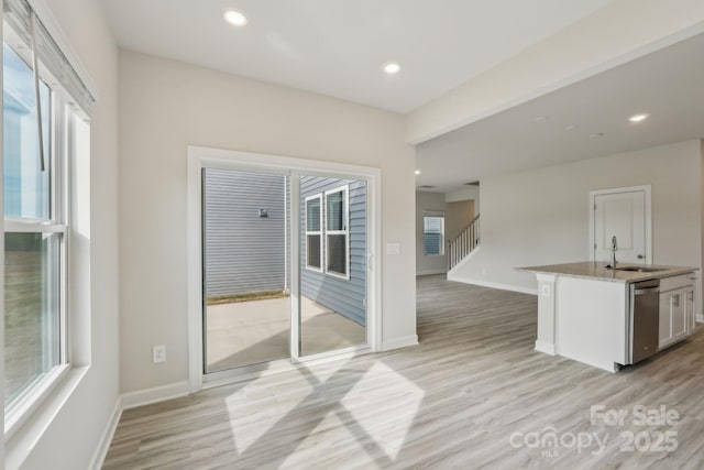 1305 31st St NE, Conover, NC 28613 - interior space featuring baseboards, light wood-type flooring, and a sink