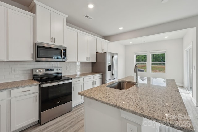 1305 31st St NE, Conover, NC 28613 - kitchen featuring a sink, stainless steel appliances, white cabinets, and light wood-style floors