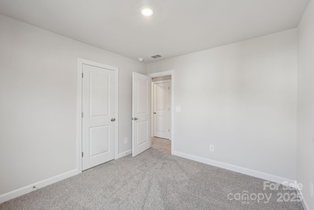 1305 31st St NE, Conover, NC 28613 - unfurnished bedroom with light colored carpet, visible vents, baseboards, and recessed lighting