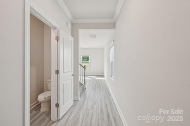1305 31st St NE, Conover, NC 28613 - corridor with light wood-style flooring, baseboards, visible vents, crown molding, and an upstairs landing