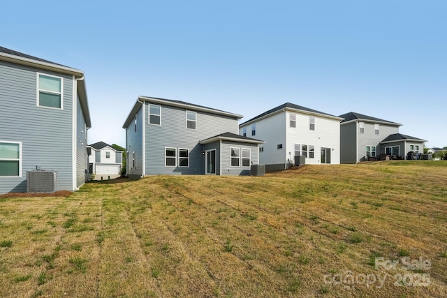 1305 31st St NE, Conover, NC 28613 - rear view of house with a yard and central AC unit