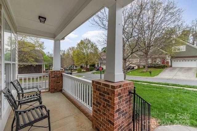 10802 Tradition View Dr, Charlotte, NC 28269 - view of patio / terrace featuring covered porch, a garage, and concrete driveway