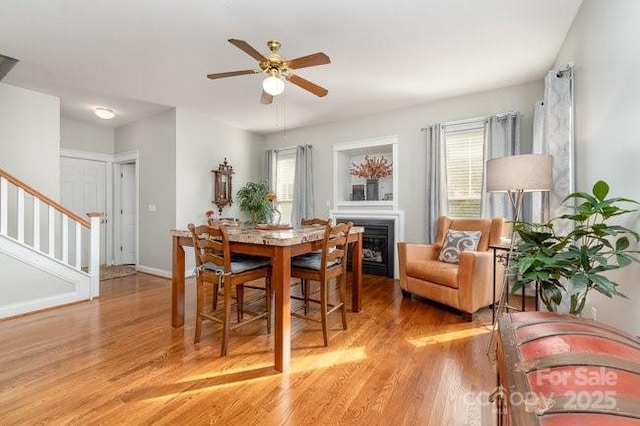 10802 Tradition View Dr, Charlotte, NC 28269 - dining room featuring a wealth of natural light, light wood-type flooring, stairway, and a ceiling fan