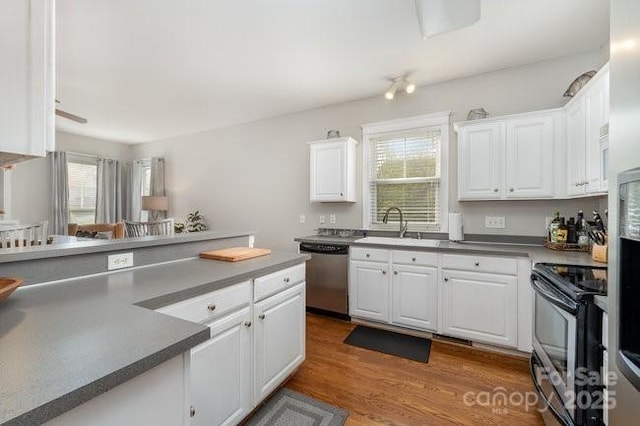 10802 Tradition View Dr, Charlotte, NC 28269 - kitchen with white cabinets, wood finished floors, a sink, and stainless steel appliances