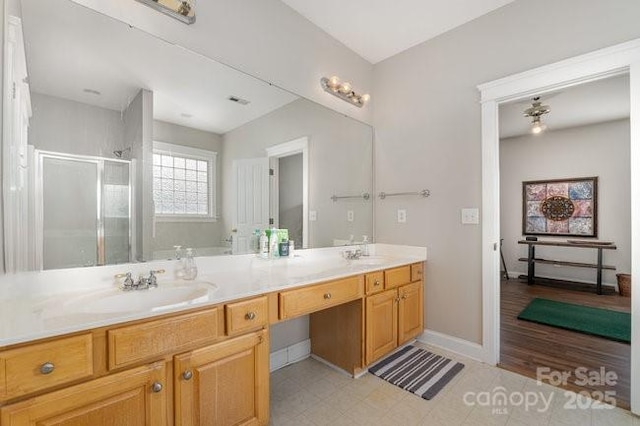 10802 Tradition View Dr, Charlotte, NC 28269 - full bath featuring baseboards, double vanity, a sink, and a shower stall