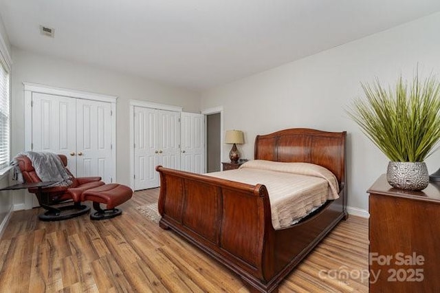 10802 Tradition View Dr, Charlotte, NC 28269 - bedroom featuring visible vents, two closets, and light wood finished floors