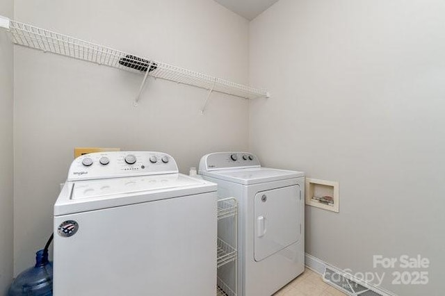 10802 Tradition View Dr, Charlotte, NC 28269 - clothes washing area with washer and clothes dryer, baseboards, and laundry area