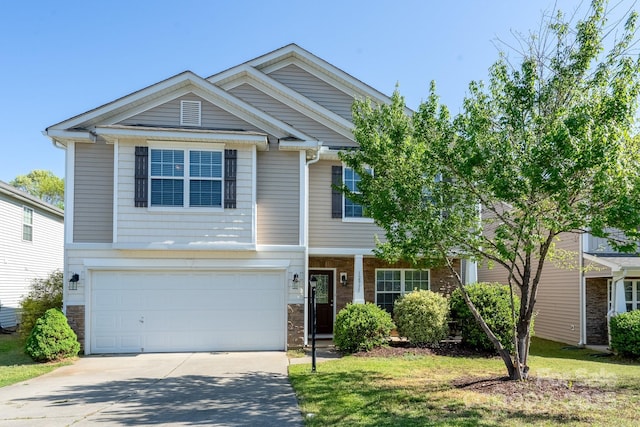 view of front facade featuring a garage, stone siding, driveway, and a front yard