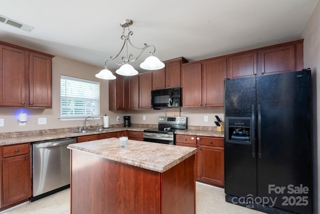 kitchen with visible vents, black appliances, a center island, light countertops, and a sink