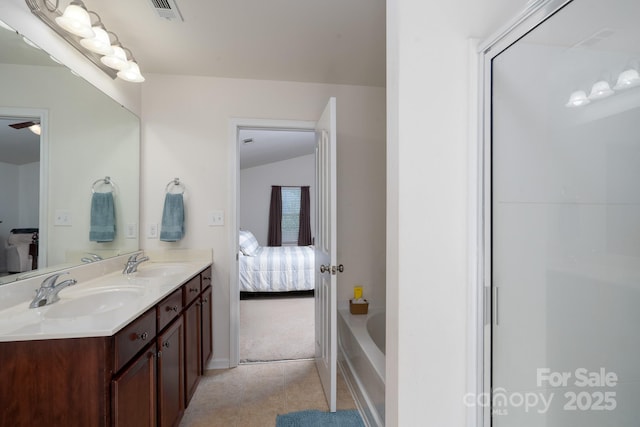 ensuite bathroom with double vanity, ensuite bath, visible vents, and a sink