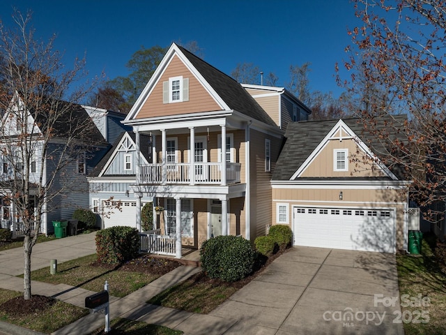 view of front of house with covered porch, an attached garage, concrete driveway, and a balcony