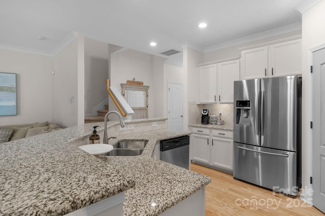 6021 Sweetbay Ln, Indian Land, SC 29707 - kitchen featuring light wood-style flooring, crown molding, stainless steel appliances, white cabinetry, and a sink