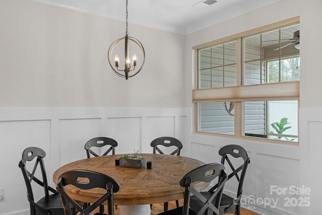 6021 Sweetbay Ln, Indian Land, SC 29707 - dining space featuring a wainscoted wall, a notable chandelier, crown molding, and visible vents