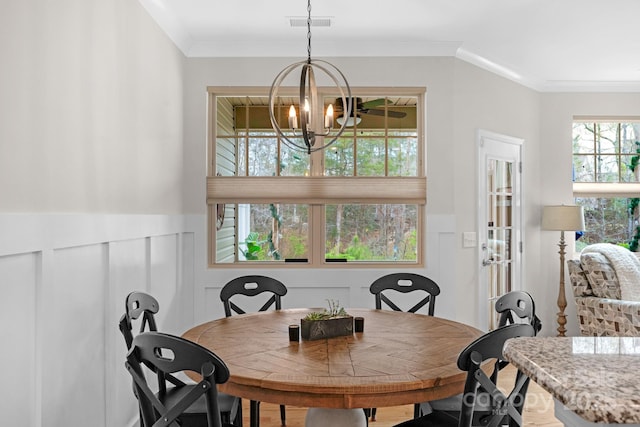 6021 Sweetbay Ln, Indian Land, SC 29707 - dining room with a wainscoted wall, visible vents, crown molding, and a chandelier