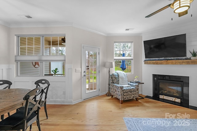 6021 Sweetbay Ln, Indian Land, SC 29707 - living area featuring wood finished floors, crown molding, a glass covered fireplace, and ceiling fan