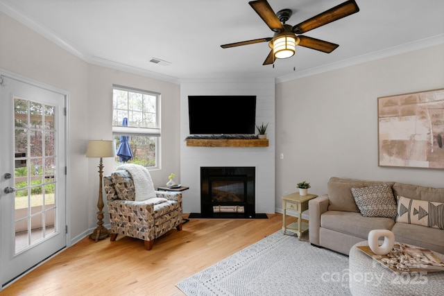 6021 Sweetbay Ln, Indian Land, SC 29707 - living area featuring visible vents, a large fireplace, wood finished floors, and crown molding