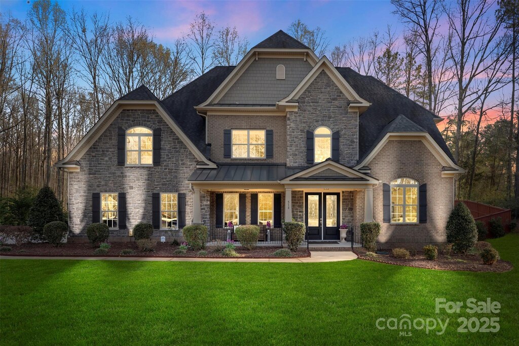 518 May Green Dr, Clover, SC 29710 - view of front of property with brick siding, stone siding, a lawn, and a porch