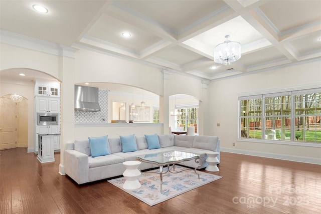 living room featuring arched walkways, a notable chandelier, plenty of natural light, and wood-type flooring