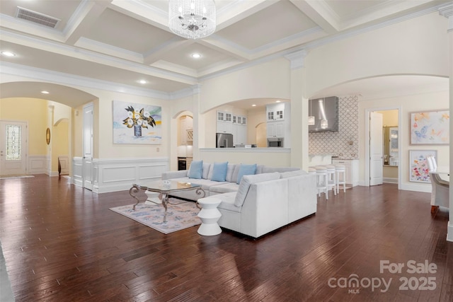 living room with beam ceiling, visible vents, coffered ceiling, and dark wood-style floors
