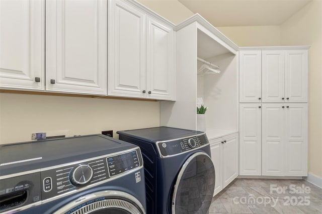 laundry area with washer and dryer and cabinet space