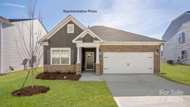 2315 Riggs Rd, Sherrills Ford, NC 28673 - craftsman house featuring a garage, driveway, central air condition unit, and a front yard