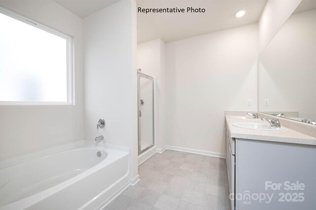 2315 Riggs Rd, Sherrills Ford, NC 28673 - bathroom featuring baseboards, double vanity, a sink, a shower stall, and a garden tub