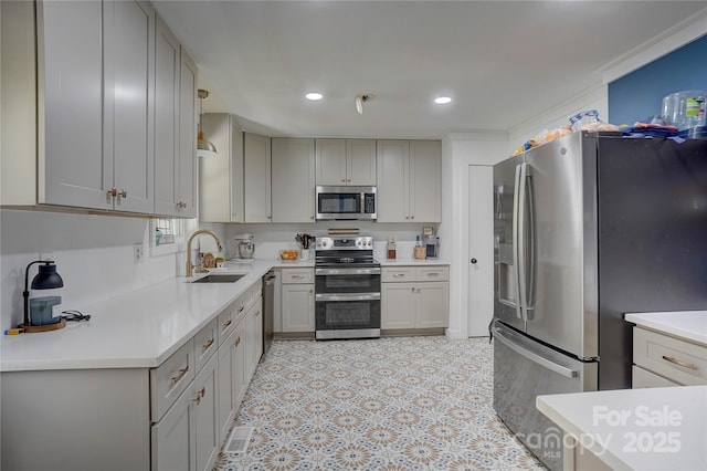 kitchen with gray cabinets, light countertops, a sink, and stainless steel appliances