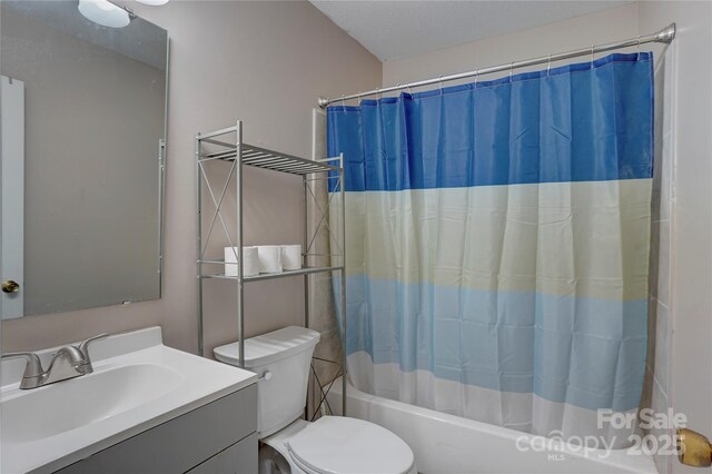 bathroom with toilet, shower / tub combo with curtain, and vanity