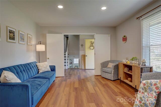 living area with recessed lighting and light wood-style floors