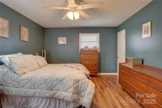 bedroom with baseboards, light wood-type flooring, and a ceiling fan
