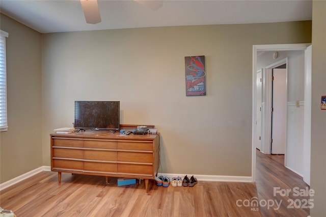 bedroom featuring baseboards, ceiling fan, and wood finished floors