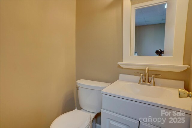 bathroom featuring toilet and vanity