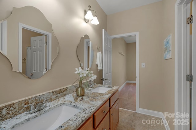 full bathroom with double vanity, a sink, and tile patterned floors