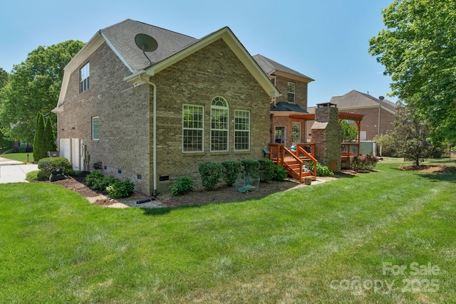 rear view of house with brick siding, crawl space, and a yard