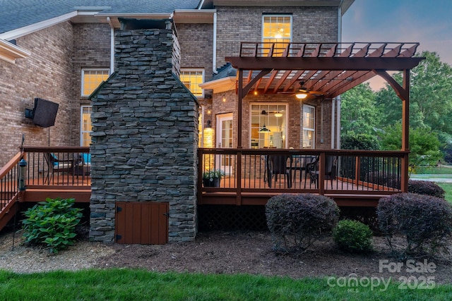 back of house featuring brick siding, a wooden deck, and stairs