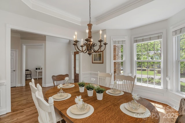 dining room with plenty of natural light, crown molding, and a chandelier