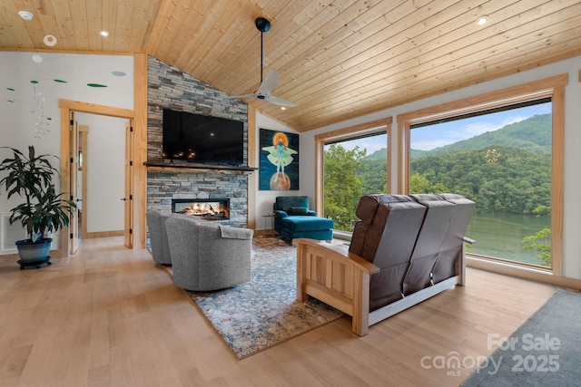 192 Lakeview Trl, Bryson City, NC 28713 - living area featuring wooden ceiling, wood finished floors, a stone fireplace, lofted ceiling, and a ceiling fan