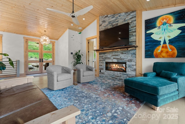 192 Lakeview Trl, Bryson City, NC 28713 - living room featuring wood ceiling, vaulted ceiling, a fireplace, a chandelier, and ceiling fan